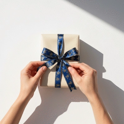 Hands wrapping a beautifully presented gift with ribbon, no text, no words, no typography, clean image